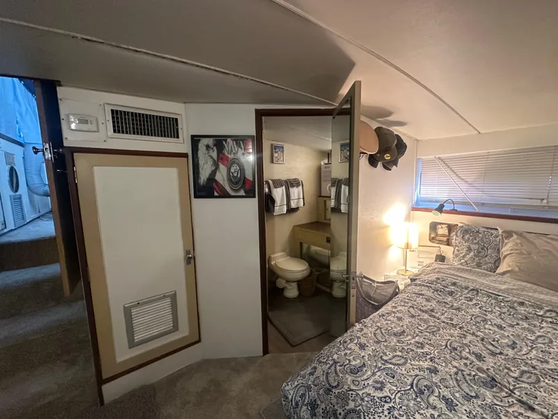 Slide: The Image of 1974 Bertram 42 Motor Yacht interior with cozy bedroom and bathroom. - 47