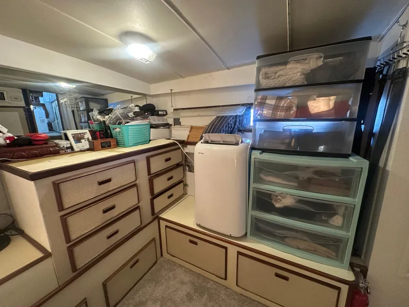 Slide: The Image of Interior of a 1974 Bertram 42 Motor Yacht with organized storage and drawers. - 49