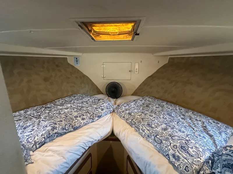 Slide: The Image of 1974 Bertram 42 Motor Yacht cabin with twin beds and patterned bedding. - 51