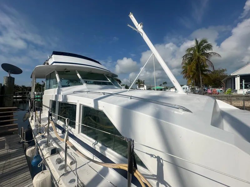 Slide: The Image of 1974 Bertram 42 Motor Yacht docked under clear blue sky. - 6