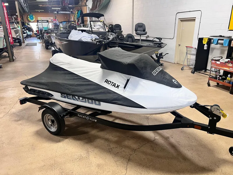 Slide: The Image of 2006 Sea-Doo GTX 155HP jet ski covered on trailer in showroom. - 7