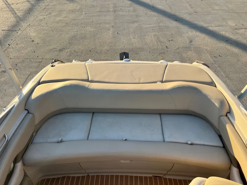 Slide: The Image of 2002 Larson LXi 190 boat interior with beige seating and wooden flooring. - 2