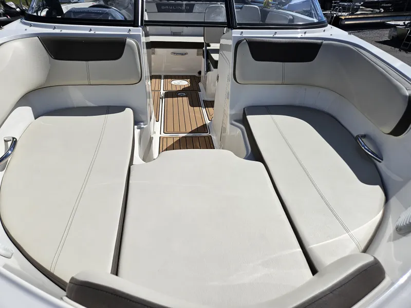 Slide: The Image of 2019 Bayliner VF5 boat interior with white seating and wood flooring. - 13