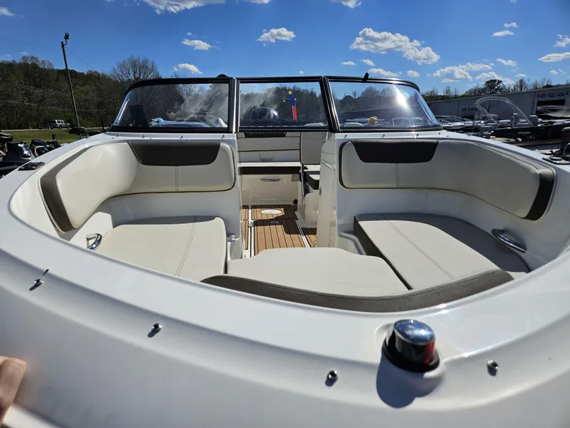 Slide: The Image of 2019 Bayliner VF5 boat interior with white seating and clear blue sky background. - 3