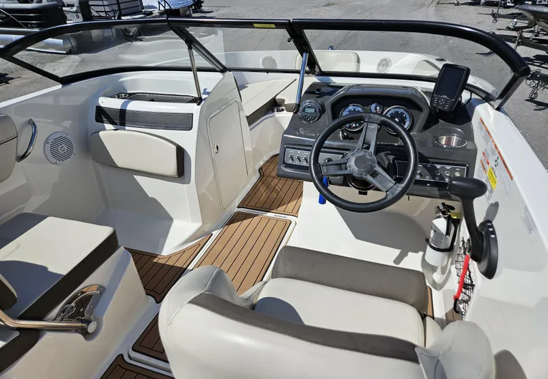 Slide: The Image of 2019 Bayliner VF5 boat interior with steering wheel, dashboard, and seating. - 9