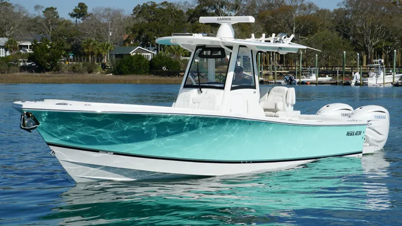 Slide: The Image of 2023 Regulator 34 boat on calm water, featuring a sleek design and vibrant turquoise hull. - 12