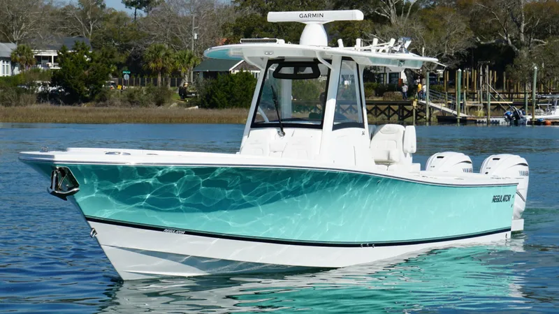Slide: The Image of 2023 Regulator 34 boat on water, featuring sleek design and vibrant turquoise hull. - 14