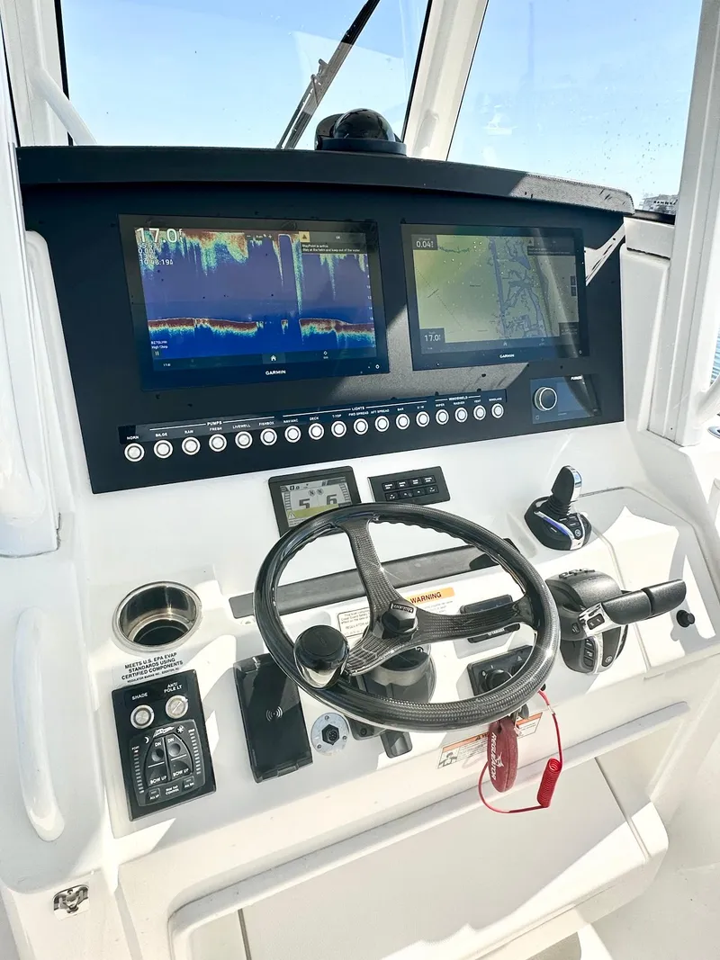 Slide: The Image of 2023 Regulator 34 boat dashboard with advanced navigation and control systems. - 15