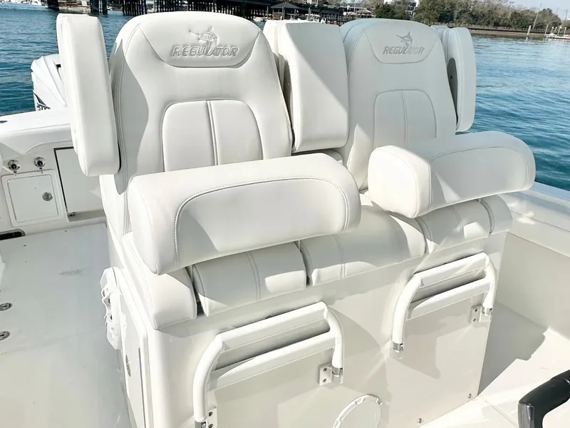 Slide: The Image of 2023 Regulator 34 boat with luxurious white seating on deck. - 18