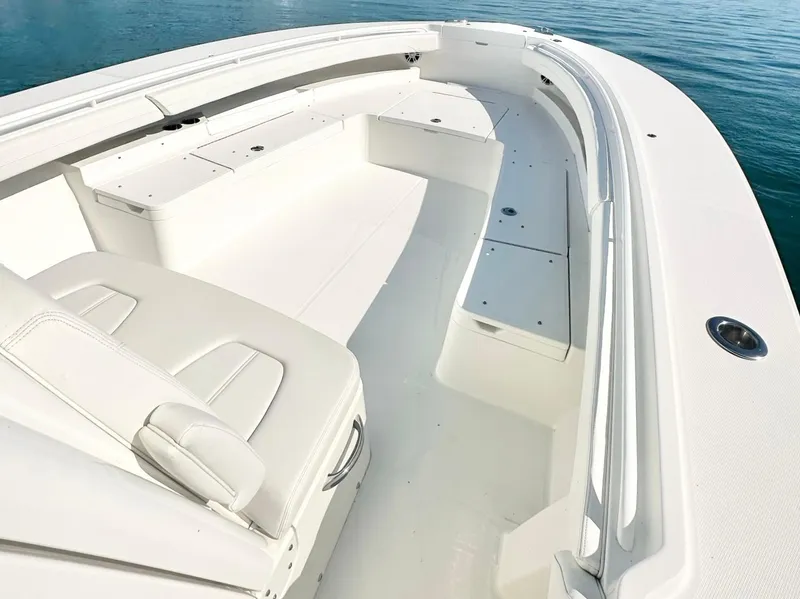 Slide: The Image of 2023 Regulator 34 boat interior with white seating and storage compartments. - 19