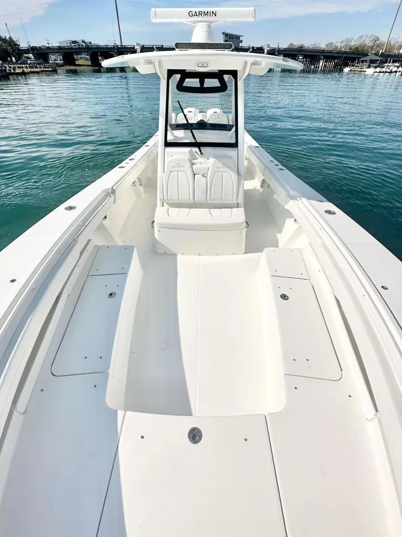 Slide: The Image of 2023 Regulator 34 boat on water, featuring spacious deck and modern design. - 20