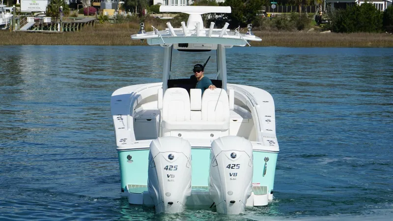 Slide: The Image of 2023 Regulator 34 boat with twin 425 V8 engines on calm water. - 8
