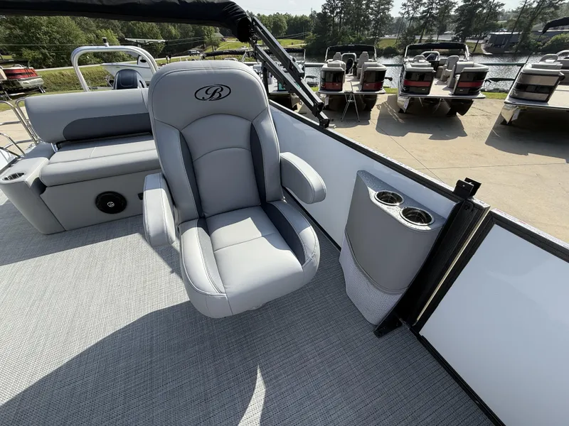 Slide: The Image of 2025 Bentley Pontoons Legacy Swingback 240 interior with gray seating and cup holders. - 10