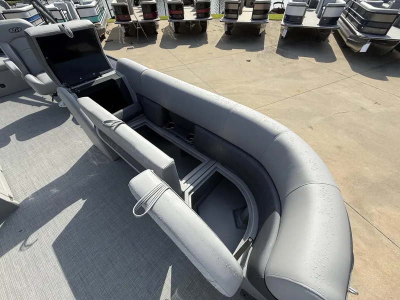 Slide: The Image of 2025 Bentley Pontoons Legacy Swingback 240 with open storage compartments and sleek seating design. - 11