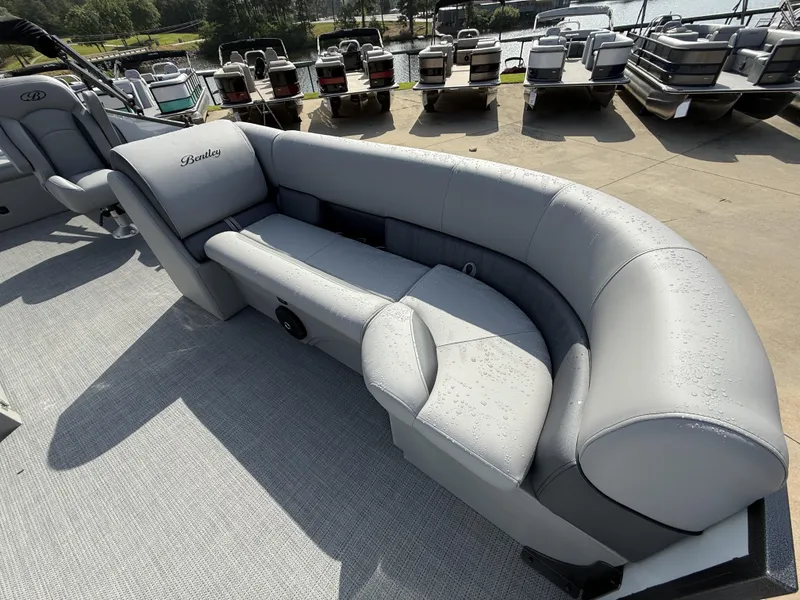 Slide: The Image of 2025 Bentley Pontoons Legacy Swingback 240 with sleek, water-resistant seating on a sunny day. - 13