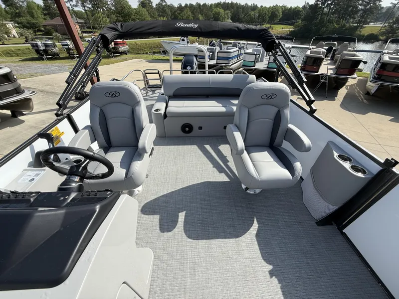 Slide: The Image of 2025 Bentley Pontoons Legacy Swingback 240 interior with plush seating and steering console. - 15