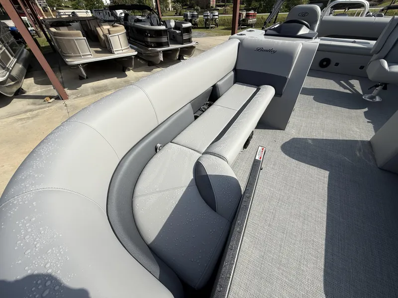 Slide: The Image of 2025 Bentley Pontoons Legacy Swingback 240 with sleek gray seating and modern design. - 4