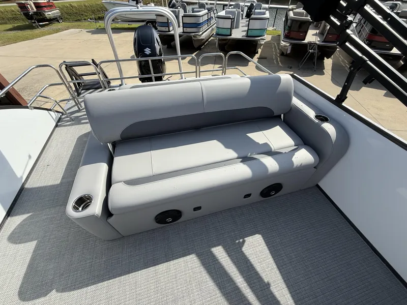 Slide: The Image of 2025 Bentley Pontoons Legacy Swingback 240 interior with gray seating and cup holders. - 6