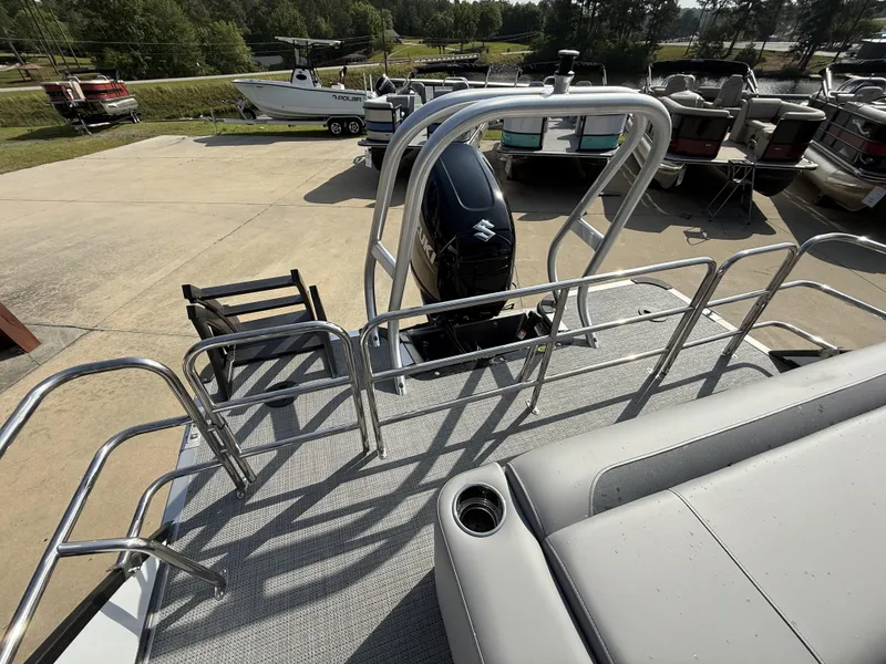Slide: The Image of 2025 Bentley Pontoons Legacy Swingback 240 with Suzuki outboard motor, docked at marina. - 8