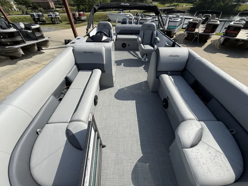 Slide: The Image of 2025 Bentley Pontoons Legacy Swingback 240 interior with gray seating and spacious layout. - 9