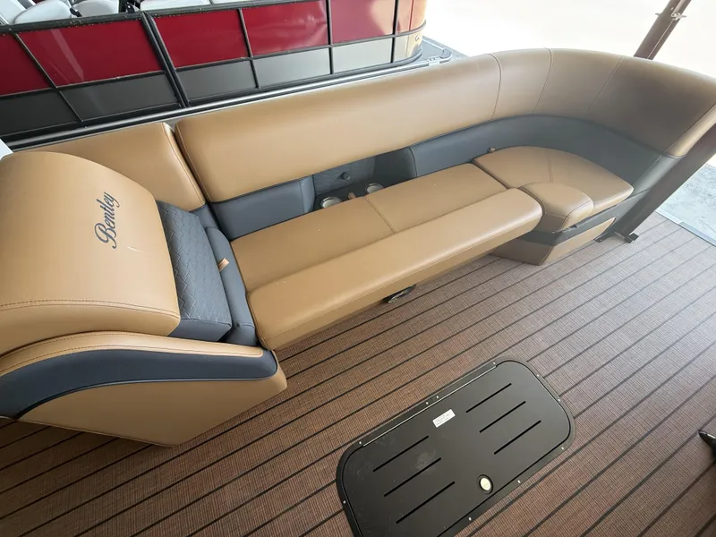 Slide: The Image of Luxurious seating on 2025 Bentley Pontoons Elite 253 Swingback, featuring tan and gray upholstery. - 10
