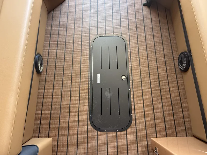 Slide: The Image of 2025 Bentley Pontoons Elite 253 interior with stylish wood-patterned flooring and seating. - 4