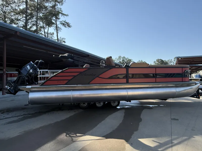 Slide: The Image of 2025 Bentley Pontoons Elite 253 Swingback Dual Captain Full Tube in a marina setting. - 6