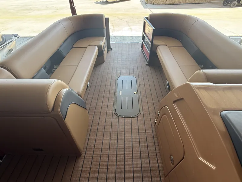 Slide: The Image of 2025 Bentley Pontoons Elite 253 interior with brown seating and spacious layout. - 9