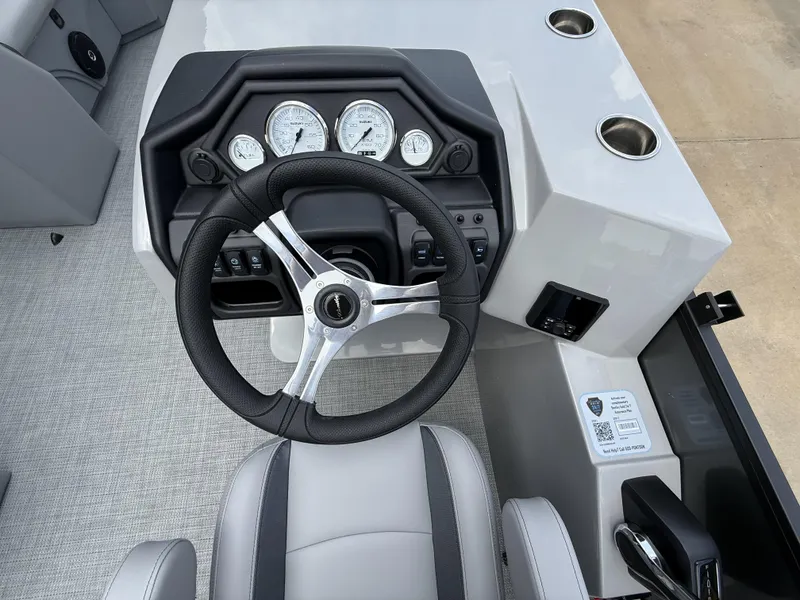 Slide: The Image of 2025 Bentley Pontoons Legacy Cruise XL 220 dashboard with steering wheel and gauges. - 10