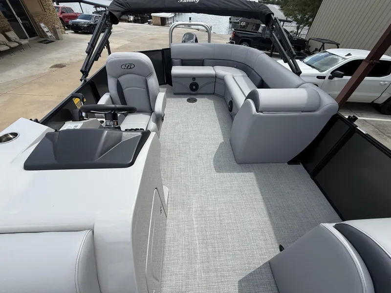 Slide: The Image of 2025 Bentley Pontoons Legacy Cruise XL 220 interior with gray seating and helm. - 4