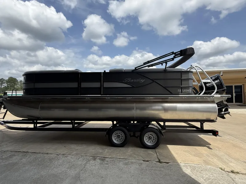 Slide: The Image of 2025 Bentley Pontoons Legacy Cruise XL 220 on trailer under cloudy sky. - 7