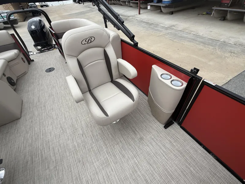 Slide: The Image of 2025 Bentley Pontoons Legacy Navigator 243 interior with beige seating and red paneling. - 10