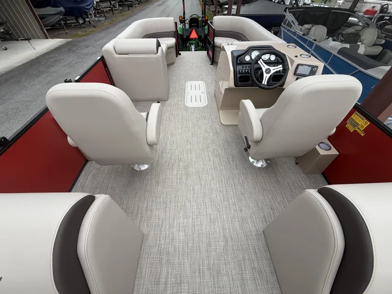 Slide: The Image of 2025 Bentley Pontoons Legacy Navigator 243 interior with beige seating and modern dashboard. - 12