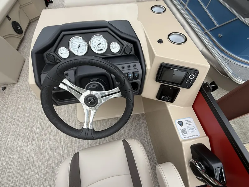 Slide: The Image of 2025 Bentley Pontoons Legacy Navigator 243 dashboard with steering wheel and control panel. - 13
