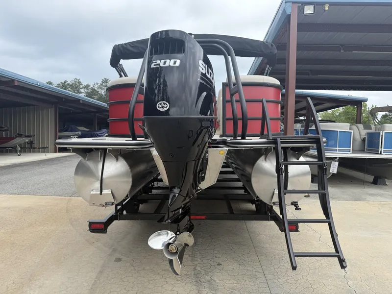 Slide: The Image of 2025 Bentley Pontoons Legacy Navigator 243 with Suzuki 200 engine, docked under a shelter. - 7