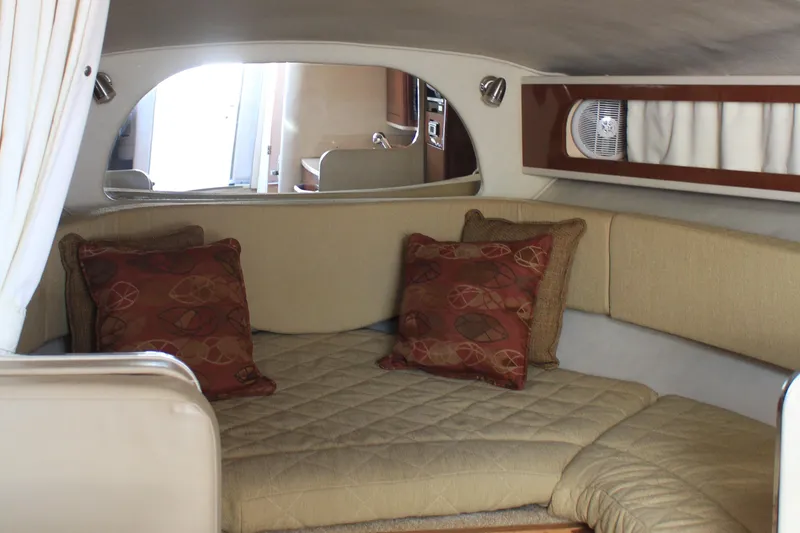 Slide: The Image of 2008 Sea Ray Sundancer cabin interior with beige seating and decorative pillows. - 10