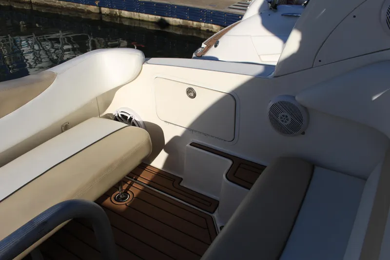 Slide: The Image of 2008 Sea Ray Sundancer boat interior with cushioned seating and wood flooring. - 12