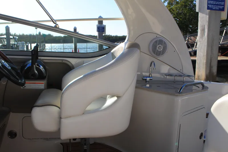 Slide: The Image of 2008 Sea Ray Sundancer cockpit with white seating and helm, featuring a compact sink. - 14