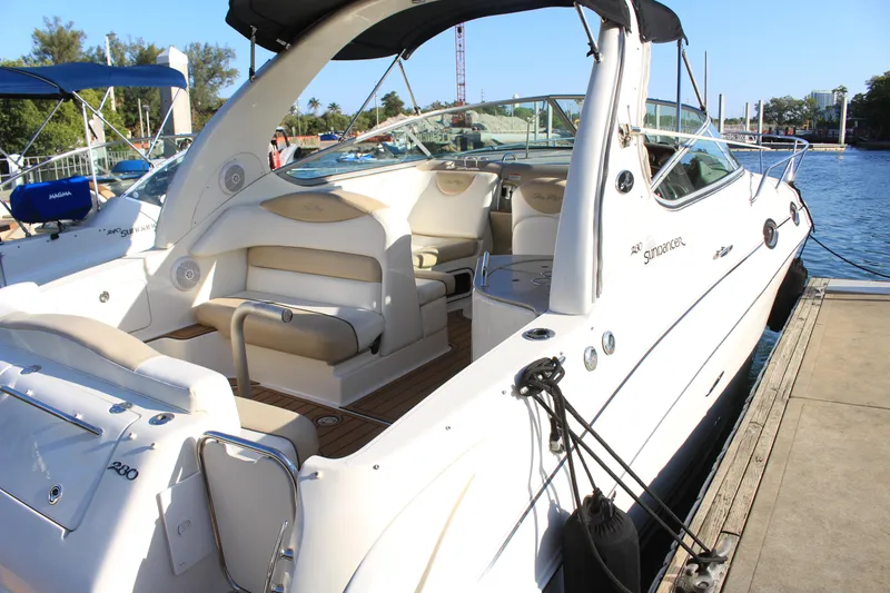 Slide: The Image of 2008 Sea Ray Sundancer boat docked, featuring spacious seating and sleek design. - 15