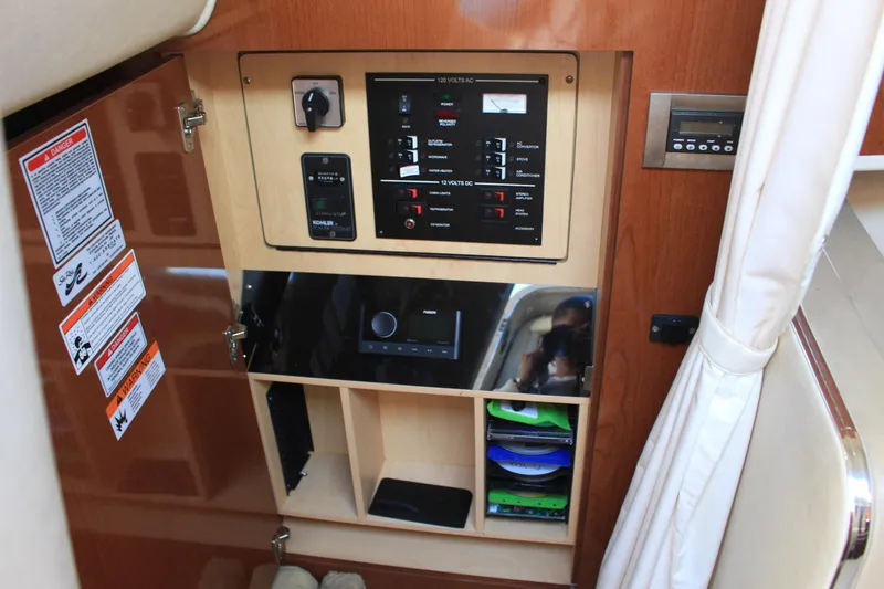 Slide: The Image of 2008 Sea Ray Sundancer control panel with switches and storage compartments. - 3