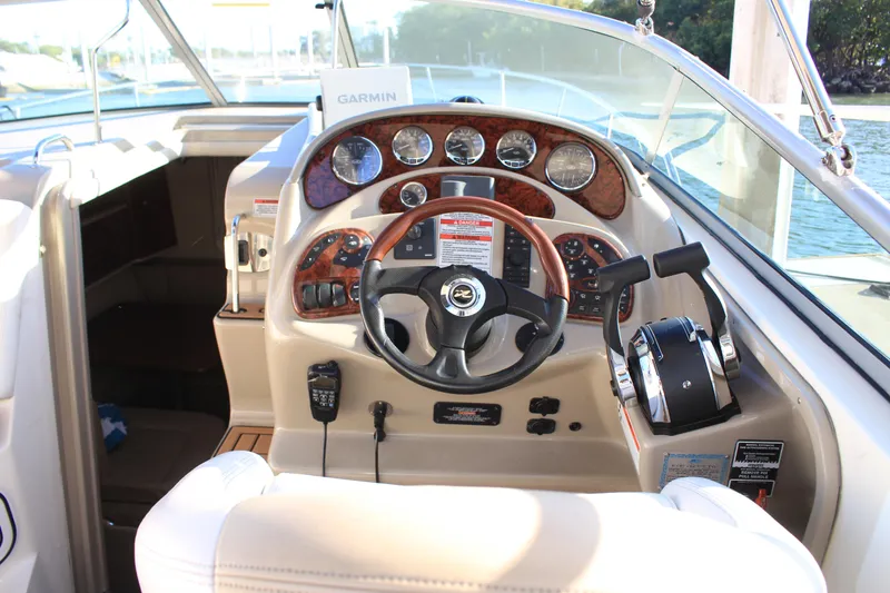 Slide: The Image of 2008 Sea Ray Sundancer helm with steering wheel, gauges, and controls. - 5