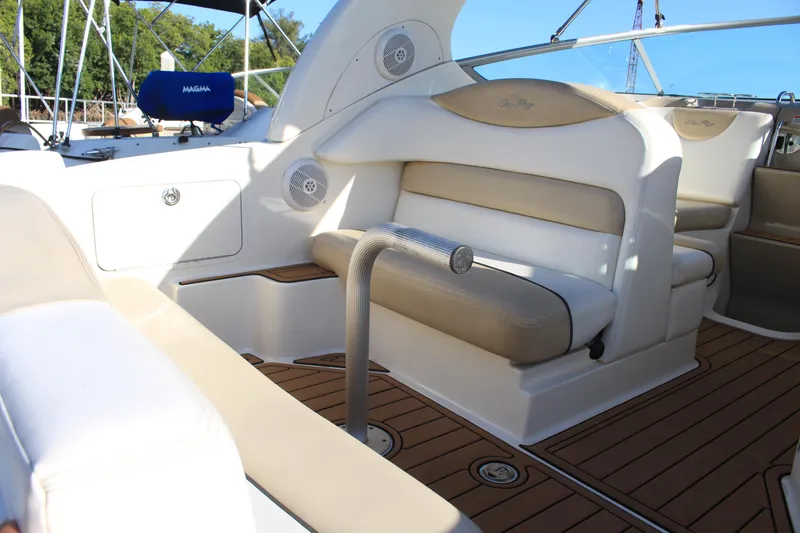 Slide: The Image of 2008 Sea Ray Sundancer boat interior with beige seating and wood flooring. - 9