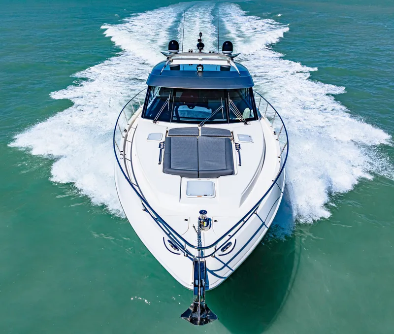 Slide: The Image of 2022 Riviera 5400 Sport Yacht cruising on open water, aerial front view. - 23