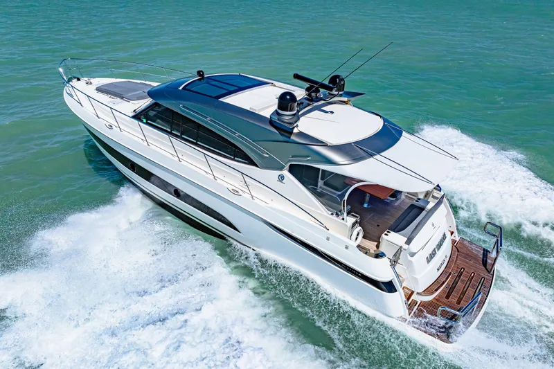 Slide: The Image of 2022 Riviera 5400 Sport Yacht cruising on open water, showcasing sleek design and luxury. - 25