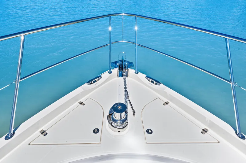 Slide: The Image of Bow of 2022 Riviera 5400 Sport Yacht on calm blue water. - 49