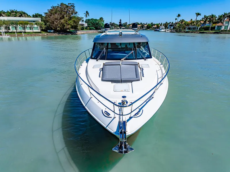 Slide: The Image of 2022 Riviera 5400 Sport Yacht on calm water, front view. - 7