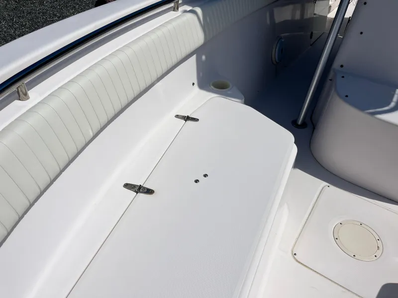 Slide: The Image of 2003 Grady-White Chase 273 boat interior with white seating and storage compartment. - 13