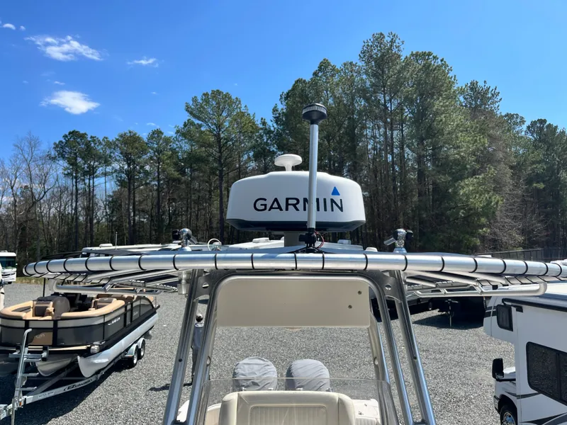 Slide: The Image of 2003 Grady-White Chase 273 boat with Garmin radar, parked outdoors near trees. - 16