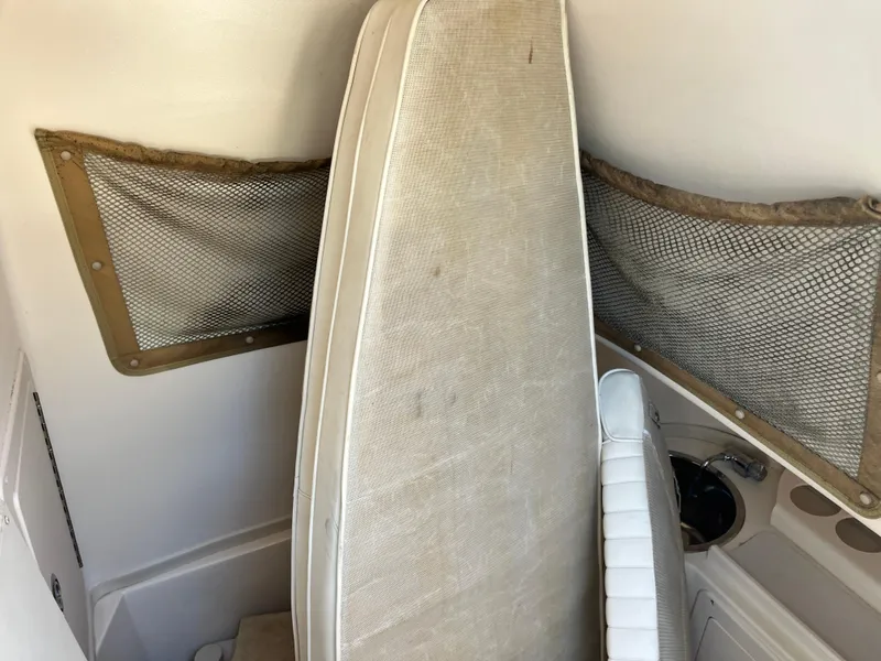 Slide: The Image of 2003 Grady-White Chase 273 boat interior with storage nets and cushions. - 17