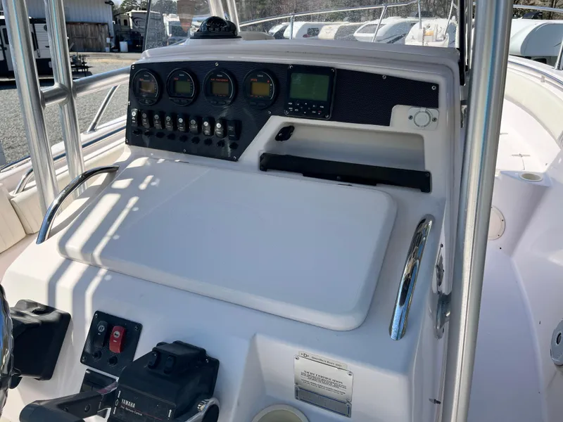 Slide: The Image of 2003 Grady-White Chase 273 boat dashboard with control panel and gauges. - 19